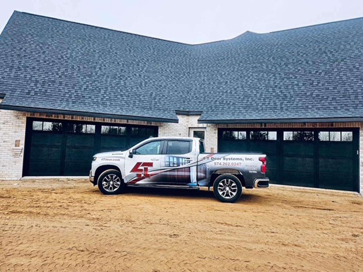 4-T Garage Door Company truck outside of a large garage with multiple Overhead Doors in Mishawaka, IN