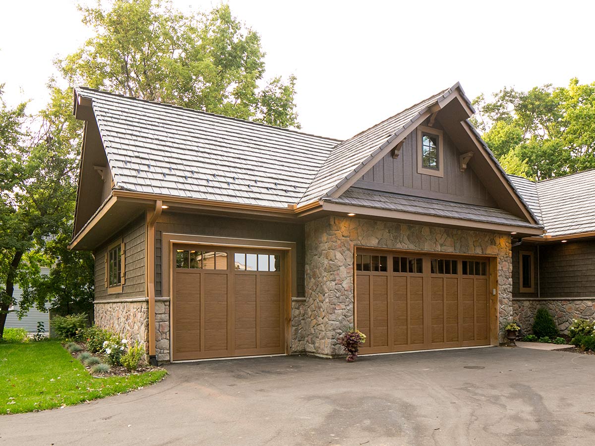 Traditional home with brown garage door installation in Edwardsburg, MI
